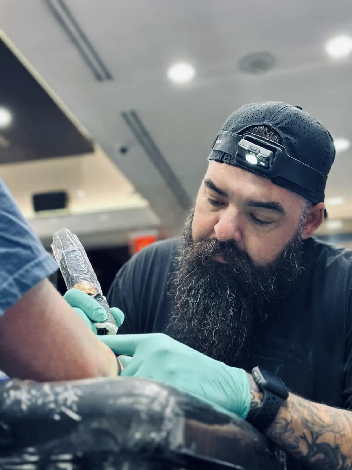 Resident tattoo artist tattooing a client